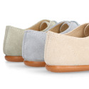 Oxford style kids shoes with shoelaces in suede leather in pastel colors.