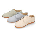 Oxford style kids shoes with shoelaces in suede leather in pastel colors.