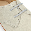 Oxford style kids shoes with shoelaces in suede leather in pastel colors.