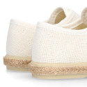 White linen canvas oxford shoe espadrille style with hook and loop closure.