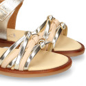 Laminated leather girl sandal shoes with braided design in gold color.