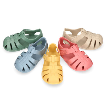 Children's barefoot jelly shoes with adhesive closure for the beach and pool.