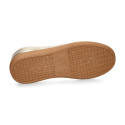 Women's fashion sports shoe with laces in gold color.