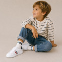 Washable leather OKAA kids School tennis shoes with laces and flag design.