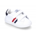 Washable leather tennis shoes laceless and with flag design.