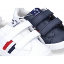 Washable leather tennis shoes laceless and with flag design.